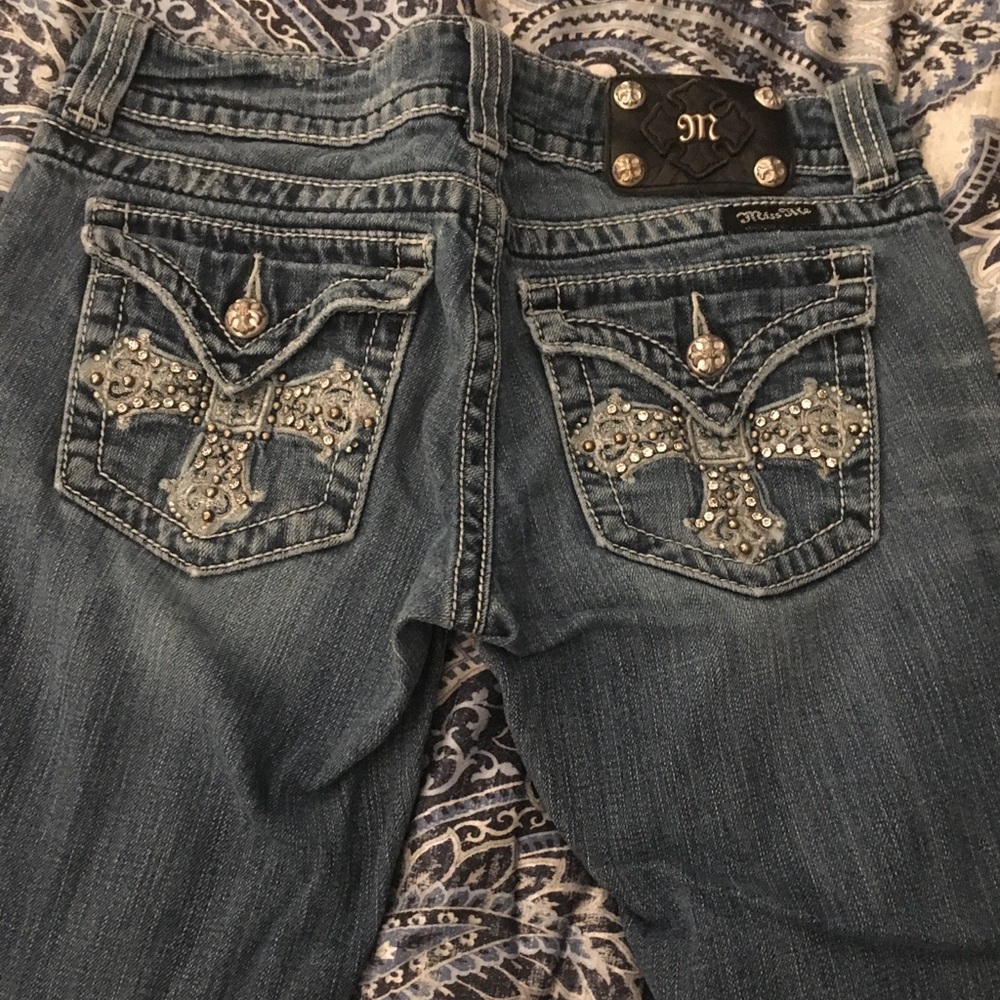 Distressed Miss Me jeans with cross